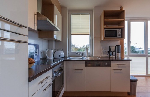 Grossenbrode Apartment | Modern vacation rental "Seestern 31" in Großenbrode. An exclusive vacation retreat with a sauna and bathtub. A sunny terrace for relaxing vacation moments. Fireplace, bike storage, and pets welcome